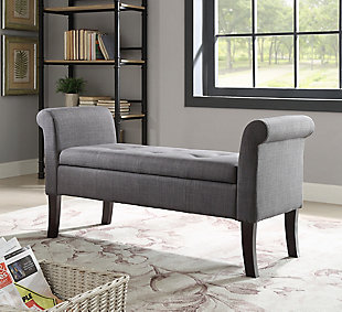 Bring form and function to an entryway, living room, hallway or bedroom with the Stacie storage bench in charcoal gray. Backless, roll arm styling is chic and sophisticated. Lift up the tufted seat to reveal ample interior storage space. Talk about comfort and convenience.Made with wood and engineered wood | Charcoal gray polyester upholstery | Tufted seat | Foam cushion | Flip-top reveals storage compartment | Exposed legs with dark espresso finish | Assembly required