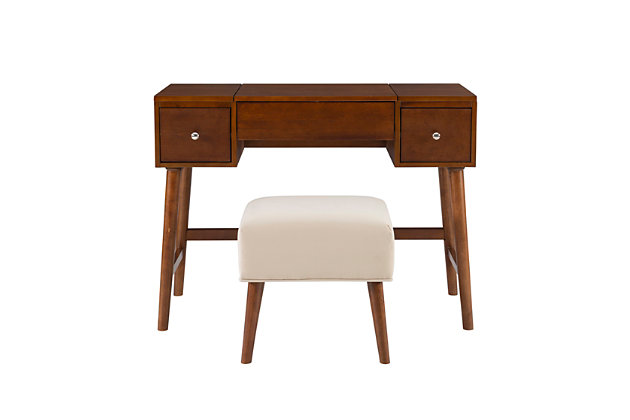 Ready yourself for the day in the versatility and mid-century style of the Maggie vanity set. Its eye-catching style includes a large tabletop, ideal for storing perfume bottles and trinkets, while two drawers provide space to keep small items organized. The flip top mirror opens to reveal additional hidden storage space. The matching stool is plush with a cushioned top upholstered in a neutral patterned fabric. What a find, a vanity that combines the elegance of the past with a design that meets today's needs.Made of rubberwood, wood, engineered wood, birch veneer, foam and fabric | Walnut-colored finish | Flip top mirror | 2 storage drawers | Includes stool with plush cushioned top upholstered in a neutral patterned fabric | Assembly required