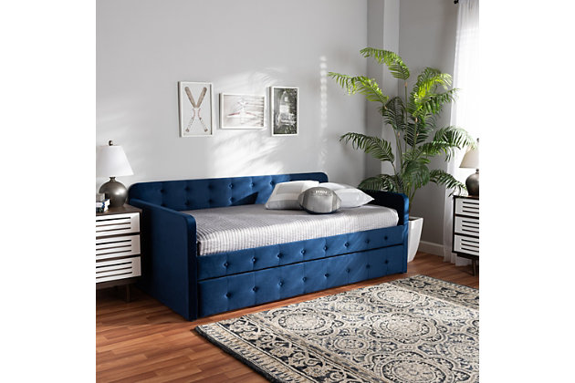Set up an elegant environment for lounging and sleeping with the Jona daybed. Made in Malaysia, this wooden daybed is upholstered in a soft, luxurious velvet fabric and padded with foam for the utmost comfort. Sleek track arms display a modern look, while button tufting lends a classic touch. Designed with both style and function in mind, the Jona is fitted with a roll-out twin size trundle bed to provide easy accommodation for overnight guests. Requiring assembly, the Jona is well suited for guest rooms and children's rooms.Roll-out twin-size trundle bed | Constructed from MDF wood and engineered wood | Upholstered in velvet fabric and padded with foam | Button tufted