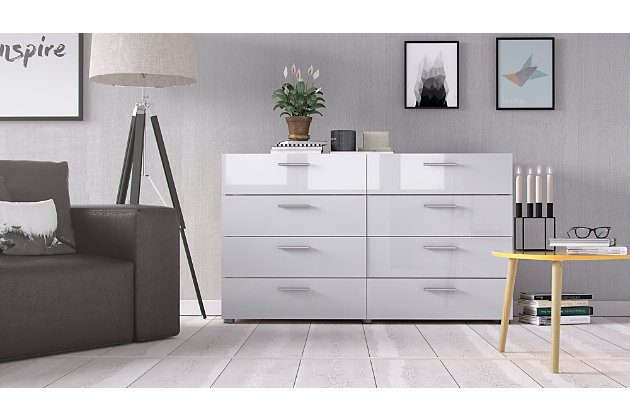 Keep it clean. The Austin eight-drawer double dresser organizes your clothes with a refined, restrained presence. Sweaters and linens find a happy home in the eight wide drawers, while the unique dresser depth makes the piece ideal for smaller spaces. Streamlined hardware and round feet give it a simply chic feel. Standing strong with an easy-to-clean foil surface, this piece is an essential. Made with engineered wood | Plastic silvertone bar handles  | 8 storage drawers | Drawers retract smoothly on metal glides | Ships in 2 boxes | Includes assembly manual and all necessary hardware and fasteners | 2 people suggested for assembly | Assembly required | Estimated Assembly Time: 5 Minutes