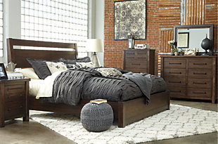 For fans of urban industrial design, the Starmore queen panel bed clearly steals the show. Its blend of acacia veneer and wood is beautified with an oiled walnut-tone finish for a highly contemporary aesthetic with natural, grainy character. Open plank detailing on the headboard and low-profile footboard perfect the look from head to toe. Mattress and foundation/box spring sold separately.Made of acacia veneers, wood and engineered wood | Includes headboard, footboard and rails | Assembly required | Foundation/box spring required, sold separately | Mattress available, sold separately | Estimated Assembly Time: 65 Minutes