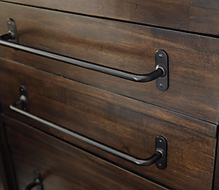 For fans of urban industrial design, the Starmore chest of drawers clearly steals the show. Its blend of acacia veneer and wood is beautified with an oiled walnut-tone finish for a highly contemporary aesthetic with wonderfully grainy character. Linear, large-scale pulls pull it all together. Five smooth-gliding drawers with dovetail construction meld quality form and function.Made of acacia veneers, wood and engineered wood | Dark bronze-tone tubular metal pulls | 5 smooth-gliding drawers with dovetail construction (2 top drawers felt lined) | Small Space Solution