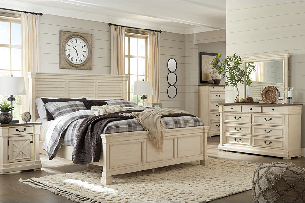 Whether your style is farmhouse fresh, shabby chic or country cottage, you’ll find the Bolanburg dresser dressed to impress. Its two-tone, gently distressed finish pairs weathered oak with antique white for that much more quaint character. The dresser’s nine smooth-gliding drawers are quality crafted with dovetail construction. Three felt-lined top drawers are another reflection of fine detail, inside and out.Dresser only | Made of veneers, wood and engineered wood | Two-tone finish (weathered oak top over antique white) | Plank-style top | 9 smooth-gliding drawers with dovetail construction (top 3 drawers felt lined) | Black faceted hardware | Includes tipover restraint device | Estimated Assembly Time: 15 Minutes