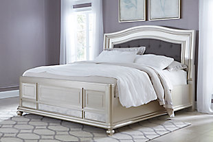 Coralayne upholstered bed allures with the glitz and glam befitting silver screen s. Exquisite frame's metallic tone channels that Hollywood Regency flair you've been dreaming of. Button-tufted fabric inlay will have you feeling sheltered in comfort and luxury. Mattress and foundation/box spring sold separately.Includes headboard, footboard and rails | Metallic sheen finish | Button-tufted polyester upholstery | Assembly required | Made of veneers, wood and manmade wood
