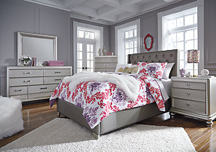 Coralayne full upholstered bed allures with the glitz and glam befitting silver screen queens. Textured gray vinyl upholstery channels that upscale flair you've been dreaming of. Generously scaled headboard with crystalline buttons will have you feeling sheltered in comfort and luxury. Mattress and foundation/box spring available, sold separately.Made of wood, engineered wood and vinyl | Includes upholstered headboard, footboard and rails | Assembly required | Mattress and foundation/box spring available, sold separately | Estimated Assembly Time: 50 Minutes