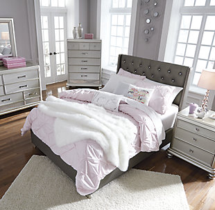 Coralayne full upholstered bed allures with the glitz and glam befitting silver screen queens. Textured gray vinyl upholstery channels that upscale flair you've been dreaming of. Generously scaled headboard with crystalline buttons will have you feeling sheltered in comfort and luxury. Mattress and foundation/box spring available, sold separately.Made of wood, engineered wood and vinyl | Includes upholstered headboard, footboard and rails | Assembly required | Mattress and foundation/box spring available, sold separately | Estimated Assembly Time: 50 Minutes