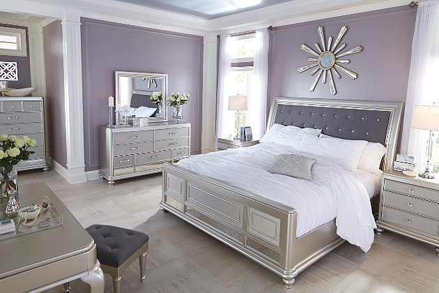 Coralayne California king sleigh bed allures with the glitz and glam befitting silver screen queens. Exquisite frame's metallic tone channels that Hollywood Regency flair you've been dreaming of. Fabric inlay with crystal-look button tufting will have you feeling sheltered in comfort and luxury. Mattress and foundation/box spring available, sold separately.Made of solid wood and engineered wood | Includes headboard, footboard and rails | Metallic sheen finish | Crystal-look button tufted polyester upholstery | Assembly required | Foundation/box spring required, sold separately | Mattress available, sold separately | Estimated Assembly Time: 40 Minutes