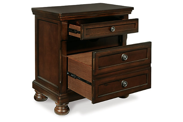 The quality craftsmanship is clear to see. The classic design elements—including antiqued hardware and bun feet—are easy to love. Satisfying your taste for traditional furnishings, the Porter nightstand is elegant without looking fussy. Two drawers—one large, one small—keep bedside odds and ends within easy reach. A hidden pull-out tray behind the bottom drawer puts your small valuables out of sight.Made of veneers, wood and engineered wood | Bun feet | Hand-finished | 2 smooth-operating drawers with dovetail construction | Top drawer with felt bottom; bottom drawer with cedar bottom | Pull-out tray behind bottom drawer | Dark bronze-tone hardware | Assembly required
