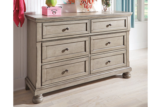 Satisfying your taste for tradition, the Lettner dresser sports serene sophistication. Forever classic design details—inlaid panels, silvertone patina hardware and bun feet—are so easy to love. A burnished light gray finish elevates the look with modern sensibility. Dresser only | Made of wood, veneer and engineered wood | Silvertone patina hardware | 6 smooth-gliding drawers with dovetail construction | Top drawers felt lined | Assembly required | Estimated Assembly Time: 15 Minutes