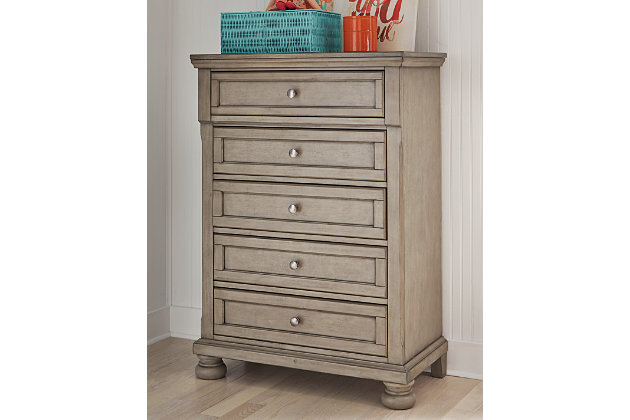 Satisfying your taste for tradition, the Lettner chest of drawers sports serene sophistication. Forever classic design details—inlaid panels, silvertone patina hardware and bun feet—are so easy to love. Its burnished light gray finish elevates the look with modern sensibility. Five roomy drawers keep your wardrobe organized in style.Made of wood, veneer and engineered wood | Silvertone patina hardware | 5 smooth-gliding drawers with dovetail construction | Top drawer felt lined | Assembly required | Estimated Assembly Time: 15 Minutes