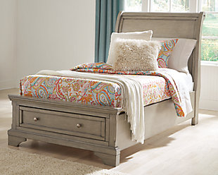 Satisfying your taste for tradition, the Lettner twin sleigh bed with storage sports serene sophistication. Forever classic design details—inlaid panels, silvertone patina hardware and bun feet—are so easy to love. Burnished light gray finish elevates the look with modern sensibility. Two roomy drawers keep your essentials organized in style. Made of veneers, wood and engineered wood | Includes headboard, footboard with storage, slats and rails | Silvertone patina hardware | 1 smooth-gliding drawer with dovetail construction | Mattress available, sold separately | Included slats eliminate need for foundation/box spring | Assembly required | Estimated Assembly Time: 55 Minutes