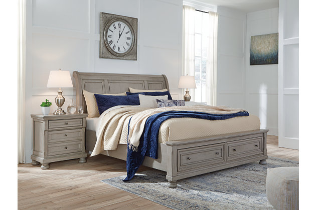 Satisfying your taste for tradition, the Lettner king sleigh bed with storage sports serene sophistication. Forever classic design details—inlaid panels, silvertone patina hardware and bun feet—are so easy to love. Burnished light gray finish elevates the look with modern sensibility. Two roomy drawers keep your essentials organized in style. Mattress available, sold separately.
Made of veneers, wood and engineered wood | Includes headboard, footboard with storage, slats and rails | Silvertone patina hardware | 2 smooth-gliding drawers with dovetail construction | Mattress available, sold separately | Bed does not require a foundation/box spring | Assembly required | Estimated Assembly Time: 70 Minutes