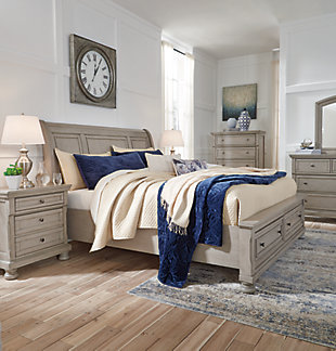 Satisfying your taste for tradition, the Lettner king sleigh bed with storage sports serene sophistication. Forever classic design details—inlaid panels, silvertone patina hardware and bun feet—are so easy to love. Burnished light gray finish elevates the look with modern sensibility. Two roomy drawers keep your essentials organized in style. Mattress available, sold separately.
Made of veneers, wood and engineered wood | Includes headboard, footboard with storage, slats and rails | Silvertone patina hardware | 2 smooth-gliding drawers with dovetail construction | Mattress available, sold separately | Bed does not require a foundation/box spring | Assembly required | Estimated Assembly Time: 70 Minutes