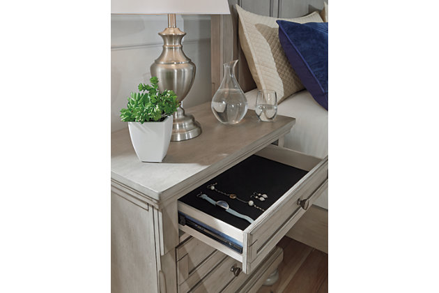 Satisfying your taste for tradition, the Lettner nightstand sports serene sophistication. Forever classic design details—inlaid panels, silvertone patina hardware and bun feet—are so easy to love. Its burnished light gray finish elevates the look with modern sensibility. Two roomy drawers keep bedside odds and ends within easy reach. A hidden pull-out tray behind the bottom drawer puts your small valuables out of sight.Made of veneers, wood and engineered wood | Silvertone patina hardware | 2 smooth-gliding drawers with dovetail construction (pull-out tray and top drawer felt lined) | Small Space Solution | Estimated Assembly Time: 15 Minutes