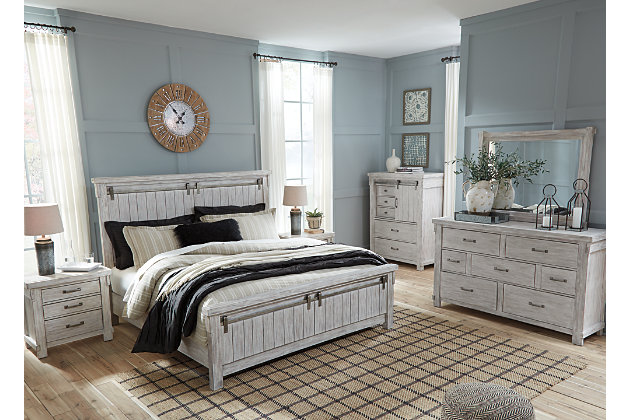 The Brashland chest of drawers brings a fresh twist to the modern farmhouse movement. Handsome, hearty profile is made all the more interesting with a sliding “barn door” revealing shelved storage. Through-tenon styling incorporates a welcome touch of American craftsman. And the easy on the eyes, distressed white finish? Just the tone for a soothing, serene bedroom retreat.Made of veneers, wood and engineered wood | White textured finish | Brushed nickel-tone hardware | 5 smooth-gliding drawers with dovetail construction | Single shelf behind sliding door | Small Space Solution | Includes tipover restraint device