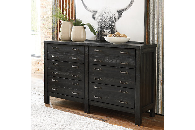 The Baylow dresser is dressed to impress with a unique twist on casually elegant farmhouse interiors. Its square, “stocky” styling is richly enhanced with plank-effect details and a distressed vintage black finish that’s not too light and not too heavy. Inspired by the old-fashioned printer’s cabinet, it includes six smooth-gliding drawers loaded with antiqued zinc-tone bar pulls.Dresser only | Made of veneers, wood and engineered wood | 6 smooth-gliding drawers with dovetail construction (top 2 drawers felt lined) | Antiqued zinc-tone hardware | Includes tipover restraint device