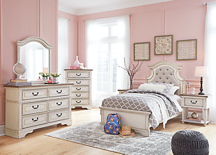 Elevating the art of traditional cottage styling, the Realyn dresser and mirror set is your dream bedroom retreat realized. This brilliantly crafted bedroom ensemble wows with dramatic scalloped details and an antiqued two-tone aesthetic blending a chipped white with a distressed wood finished top for added charm. Framed drawer fronts and decorative corbels add refinement, while bail pulls in a dark bronze-tone finish lend a classic touch.Made of veneers, wood and engineered wood, with cast resin components | Antiqued two-tone finish | 6 smooth-gliding drawers with dovetail construction | Dark bronze-tone hardware | Mirror attaches to back of dresser | Assembly required | Includes tipover restraint device | Estimated Assembly Time: 35 Minutes