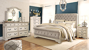 Elevating the art of traditional cottage styling, the Realyn California king upholstered sleigh bed is your dream bedroom retreat realized. A curvaceous beauty, this brilliant upholstered bed wows with a distressed chipped white finish for heirloom appeal. Deep tufting on the cushioned upholstered headboard and footboard adds such a cozy element sure to put you at ease. Mattress and foundation/box spring available, sold separately.Made of wood and engineered wood | Includes headboard, footboard and rails | Distressed, chipped white finish | Polyester upholstery with foam cushion and button tufting | Assembly required | Foundation/box spring required, sold separately | Mattress available, sold separately | Estimated Assembly Time: 70 Minutes