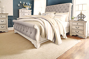 Elevating the art of traditional cottage styling, the Realyn queen upholstered sleigh bed is your dream bedroom retreat realized. A curvaceous beauty, this brilliant upholstered bed wows with a chipped white finish for heirloom appeal. Deep tufting on the cushioned upholstered headboard and footboard adds such a cozy element sure to put you at ease. Mattress and foundation/box spring available, sold separately.Made of wood and engineered wood | Includes headboard, footboard and rails | Distressed, chipped white finish | Polyester upholstery with foam cushioned and button tufting | Assembly required | Foundation/box spring required, sold separately | Mattress available, sold separately | Estimated Assembly Time: 70 Minutes