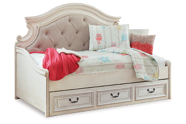 Elevating the art of traditional cottage styling, the Realyn day bed with storage is your dream bedroom retreat realized. A curvaceous beauty, this brilliant upholstered bed wows with dramatic scalloped details and fanciful trim work and charms with a distressed chipped white finish for heirloom appeal. Deep tufting on the cushioned upholstered bedstead adds such a cozy element sure to put you at ease. Mattress available, sold separately.Made of veneers, wood and engineered wood, with cast resin components | Includes day bed and under bed storage unit | Distressed, chipped white finish | Polyester upholstery with foam cushion and button tufting | Day bed uses mattress only, no box spring required | Assembly required | Mattress available, sold separately | Estimated Assembly Time: 50 Minutes