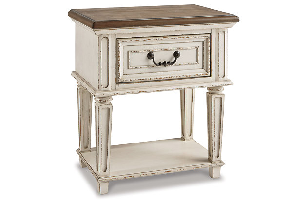 Elevating the art of traditional cottage styling, the Realyn nightstand is your dream bedroom retreat realized. Antiqued two-tone aesthetic blends a chipped white with a distressed wood finished top for added charm. Adorned with classic bail pull hardware, the smooth-gliding drawer is crafted with quality dovetail construction for years of satisfaction.Made of veneers, wood and engineered wood | Antiqued two-tone finish | Smooth-gliding drawer with dovetail construction | Dark bronze-tone finished metal hardware | Open display shelf | Estimated Assembly Time: 15 Minutes