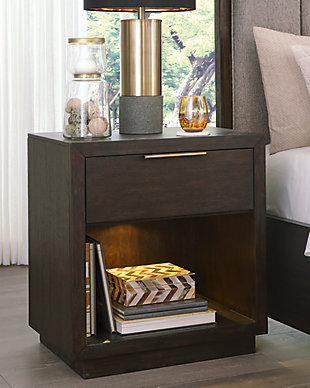 If you find that sleek and simple does the trick, we think you’ll agree: the Bruxworth nightstand has the look perfected. Always on trend espresso-tone finish and clean lines ensure an aesthetic that never goes out of style. A single drawer and an open display shelf lighten the design, while a night light inside the cubby discretely lights your way in a dark room. Picture frame moulding and a goldtone pull are on the cutting edge of cool.Made of wood, mango veneer and engineered wood | Dark espresso brown finish | Metal pull with goldtone finish | 1 smooth-gliding drawer with dovetail construction and felt bottom; open cubby with integrated night light | 2 electrical outlets and 2 USB charging ports | Power cord included; UL Listed | Assembly required
