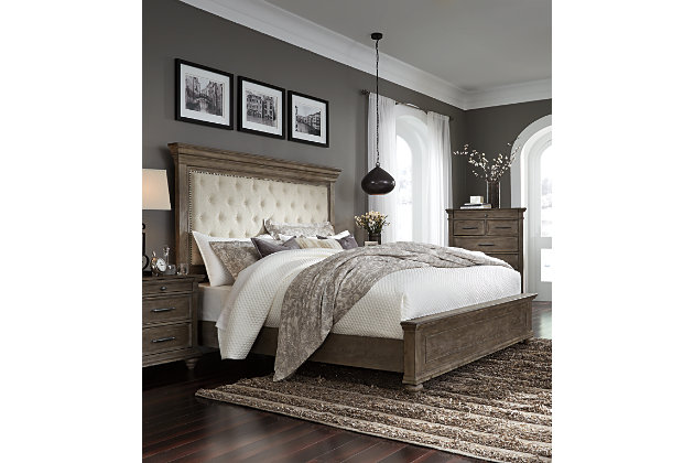 Homey. Hearty. Heavenly hued. Luring with a distressed weathered gray finish, substantial mouldings and a tall mansion-style headboard with great presence, the Johnelle queen upholstered bed is sure to make your homestead feel that much more like home. The look is beautified with elm veneers for a richly crafted master suite masterpiece made for years of satisfaction. Inset headboard cushion with tufted upholstery and dark pewter-tone nailhead trim adds comfort and a sense of indulgence. Whether your aesthetic is classic, eclectic or modern farmhouse, rest assured, this high-style, high-quality queen upholstered bed is an inspired choice. Mattress and foundation/box spring available, sold separately.Made of elm veneers, acacia wood and engineered wood | Includes upholstered headboard, footboard and rails | Distressed weathered gray finish | Polyester upholstery with dark pewter-tone nailhead trim | Assembly required | Foundation/box spring required, sold separately | Mattress available, sold separately | Estimated Assembly Time: 55 Minutes