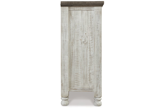 What a fresh interpretation of country classic style. Inspired by American farmhouse craftsmanship, but with an elevated sensibility, the Havalance dresser blends distinctive details such as turned post accents and raised drawer fronts for a substantial look that feels right at home. Those who appreciate rustic character should take note of this dresser’s thick profile crown moulding and stylish center cabinet, beautified with a vintage two-tone finish.Dresser only | Made of pine wood, pine veneer and engineered wood | Two-tone finish; distressed weathered gray top with distressed vintage white base | Antiqued iron-tone hardware | 8 smooth-gliding drawers with dovetail construction | Center cabinet with adjustable shelf | Top drawers with felt lining | Includes tipover restraint device | Assembly required | Estimated Assembly Time: 15 Minutes