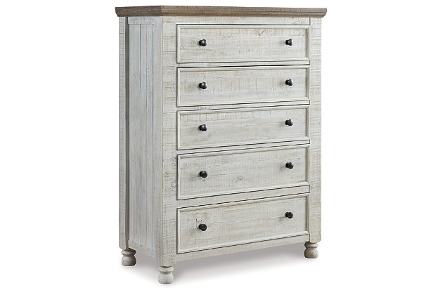 What a fresh interpretation of country classic style. Inspired by American farmhouse craftsmanship, but with an elevated sensibility, the Havalance chest of drawers blends distinctive details such as turned post accents and raised drawer fronts for substantial look that feels right at home. Those who appreciate rustic character should take note of this chest’s thick profile crown moulding, beautified with a vintage two-tone finish.Made of pine wood, pine veneer and engineered wood | Two-tone finish; distressed weathered gray top with distressed vintage white base | Antiqued iron-tone hardware | 5 smooth-gliding drawers with dovetail construction | Top drawer with felt lining | Small Space Solution | Includes tipover restraint device | Estimated Assembly Time: 15 Minutes