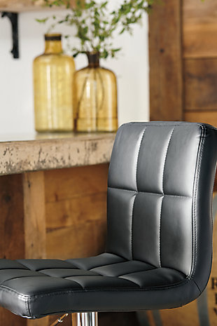 This upholstered swivel bar stool is ultra-contemporary style with a twist. Chrome-tone metal base is a sleek complement to the tailored cushioned seat with faux leather upholstery and squared tufting.360-degree swivel | Chrome-tone tubular metal base | Cushioned seat with faux leather upholstery | Adjustable height (moves from counter to pub height) | Footrest and weighted pedestal base | Assembly required | Excluded from promotional discounts and coupons | Estimated Assembly Time: 15 Minutes