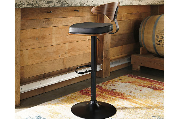 Style takes quite a modern turn. Sporting a distinctively contoured back, this upholstered swivel bar stool is sure to bring an elevated look to your living space. Wrapped in a black faux leather upholstery, the seating area’s artful contours put the accent on comfort.360-degree swivel | Matte black tubular metal base | Cushioned seat with black faux leather upholstery | Adjustable height (moves from counter to pub height) | Footrest and weighted pedestal base | Assembly required | Excluded from promotional discounts and coupons | Estimated Assembly Time: 15 Minutes