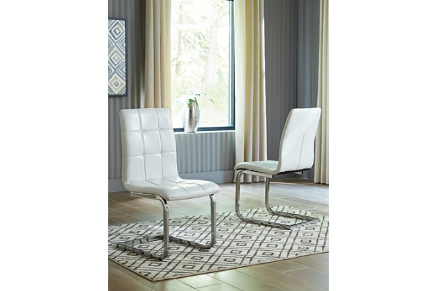 Wowing with a slim but sturdy profile and sculptural C-frame design, the Madanere dining room upholstered chair is sure to whet your appetite for ultra-contemporary style. Comfortably contoured seat is covered in a fabulous white faux leather with subtle grid tufting. Metal frame’s chrome-tone finish contrasts with a high-sheen effect.Metal frame in chrome-tone finish | Cushioned seat with grid tufting | Polyurethane upholstery | Assembly required | Estimated Assembly Time: 15 Minutes