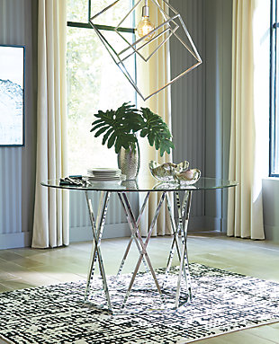 Wowing with an open and airy but sturdy profile, the Madanere 5-piece dining room set is sure to whet your appetite for ultra-contemporary style. Sporting a chrome-tone finish for a high-sheen effect, the table’s hexagonal metal base is striking from every angle. Clear glass top rounds out the look with sheer simplicity. The chair’s sculptural C-frame design and comfortably contoured faux leather seat will have you lingering at the table long after the meal is done.Includes dining table and 4 chairs | Metal frame in chrome-tone finish | Assembly required | Table has clear, tempered glass top with beveled edge | Table seats 4 | Chair has cushioned seat with grid tufting | Polyurethane (faux leather) upholstery | Estimated Assembly Time: 90 Minutes