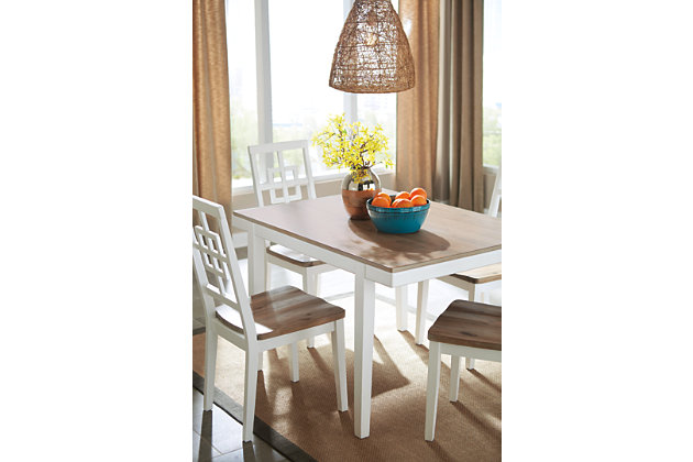 With its delicious two-tone finish, the Brovada dining room table set dishes out a double serving of clean-lined, contemporary style. Tabletop and seats are treated to a light-washed effect with hints of gray for a “weathered” aesthetic—a delightful complement to the fresh, crisp white. Open, airy lattice-back chairs really bring the look home.Includes dining table and 4 chairs | Made of wood and engineered wood | Two-tone finish | Estimated Assembly Time: 90 Minutes