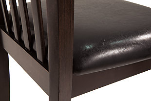 If contemporary tantalizes your taste buds, savor the beauty of this sleek upholstered dining room side chair. Rake back design complements an open and airy aesthetic. Dark and dramatic finish makes a bold, beautiful statement.Wood frame | Cushioned seat with vinyl upholstery | Assembly required | Excluded from promotional discounts and coupons | Estimated Assembly Time: 30 Minutes