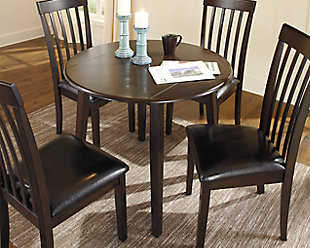 You might be short on space, but you can still long for style. If contemporary tantalizes your taste buds, savor the beauty of this sleek drop leaf dining table. Dark and dramatic, it packs plenty of appeal into a compact design.Made of veneers, wood and engineered wood | Seats up to 4 | Hinged drop leaves | Assembly required | Excluded from promotional discounts and coupons | Dining chairs sold separately | Estimated Assembly Time: 15 Minutes