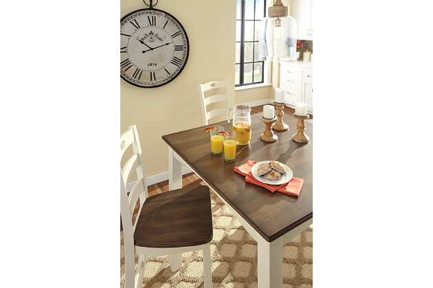 Showcasing storybook charm in the most simplified and beautiful way, the Woodanville 5-piece dining set is cottage style, freshly served. Brown tabletops and stool seats add a warm touch to the white table base and chair frame. Table’s arched aprons and the stools’ pierced ladderback design factor in plenty of appeal. Contoured seats add comfort as you sit and enjoy your time here.Includes counter height dining table and 4 ladderback stools | Made of veneers, wood and engineered wood | Assembly required | Estimated Assembly Time: 90 Minutes