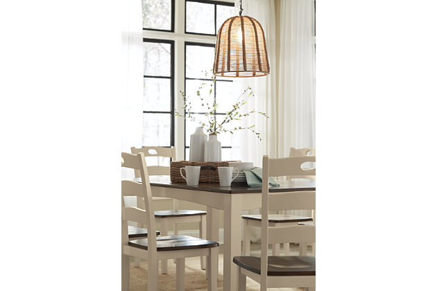 Turn your eat-in kitchen or dining room into a cottage-chic retreat with the Woodanville dining room table set. Distinctive elements include a two-tone finish for a double helping of charm and shapely arched aprons. Six pierced ladderback dining chairs are a classic complement.Includes dining room table and 6 dining room chairs | Made of veneers, wood and engineered wood | Two-tone finish | Estimated Assembly Time: 90 Minutes