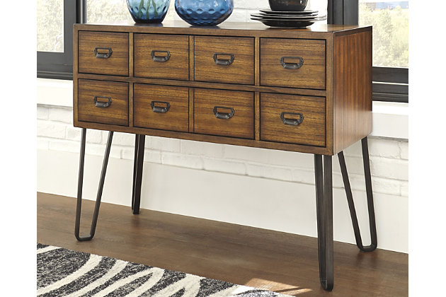 Rustic meets mid-century for a modern look in this versatile sideboard. Grainy wood paired with curved metal legs offers a mix of texture that is intriguing and simple. Stylish and practical, this statement piece with six smooth-gliding drawers allows for necessary storage from the living room and dining room.Made of veneers, wood, engineered wood and metal | 6 drawers | Dark bronze pulls | Assembly required | Excluded from promotional discounts and coupons | Estimated Assembly Time: 15 Minutes