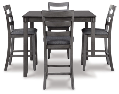 It’s so easy being gray—at least the Bridson 5-piece dining set makes it seem that way. This transitional counter-height table and barstool ensemble sports a charcoal gray finish with textured gray upholstery for an on-trend and relevant appeal. Plushly upholstered seat cushion in a practical polyfiber makes it a pleasure to linger at the table. Best of all, square table design is ideally suited for small spaces.Includes counter height table and 4 barstools | Made of wood, veneer and engineered wood | Medium charcoal gray finish | Ladderback barstools | Cushioned seats covered in textured gray polyester upholstery | Table with tapered leg design | Assembly required | Estimated Assembly Time: 90 Minutes