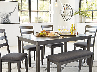 It’s so easy being gray—at least the Bridson 6-piece dining set makes it seem that way. This transitional dining table set sports a charcoal gray finish with textured gray upholstery for an on-trend and relevant appeal. Plushly upholstered seat cushions in a practical polyfiber make it a pleasure to linger at the table. Brilliantly styled seating choices add interest and versatility at mealtime.Includes dining table, bench and 4 dining chairs | Made of wood, veneer and engineered wood | Medium charcoal gray finish | Ladderback chairs | Cushioned seats covered in textured gray polyester upholstery | Table with tapered leg design | Assembly required | Estimated Assembly Time: 90 Minutes