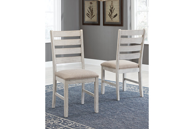 The Skempton dining chair invites you to raise the bar for small space living. An inspired choice for coastal chic or modern farmhouse settings, this comfortably cushioned chair sports a grayish white finish with rub through effect for timeworn appeal.Made of wood and engineered wood | Distressed grayish white finish | Cushioned seat with polyester upholstery | Tall ladderback design | Assembly required | Estimated Assembly Time: 30 Minutes