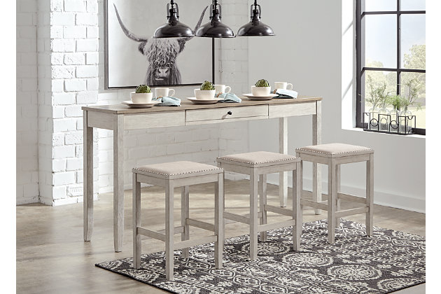 The Skempton counter height table and bar stool set invites you to raise the bar on small space living. An inspired choice for coastal chic or modern farmhouse settings, this clean-lined, simply striking set doubles the charm with brown tone plank effect tops, paired with grayish white bases with rub through effect for timeworn appeal. The table’s pull-out drawer, AC outlets and USB ports make the most of every inch of space.Includes counter height table and 3 bar stools | Made of wood, acacia veneer and engineered wood | Distressed grayish white finish | Cushioned seat with polyester upholstery | Single smooth-gliding drawer | Includes 2 USB ports and AC power outlet; UL Listed | Assembly required | Estimated Assembly Time: 60 Minutes