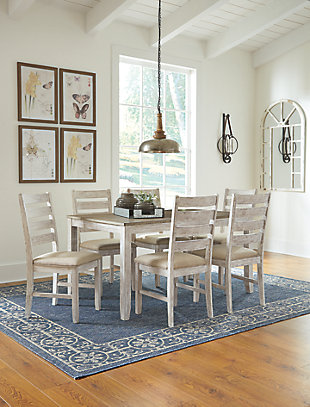 Set the scene for coastal chic or modern farmhouse living with the Skempton dining room table set. Clean-lined, simply striking table doubles the charm with a brown tone top with plank effect, paired with a grayish white base with rub through effect for timeworn appeal. Six chairs with classic ladderback styling and comfortably upholstered seats make room for one and all.Includes rectangular table and 6 chairs | Made of solid wood, engineered wood and acacia veneers | Two-tone finish | Seats up to 6 | Assembly required | Estimated Assembly Time: 90 Minutes