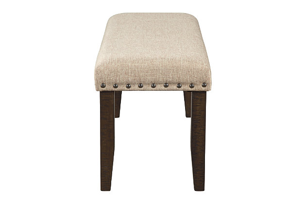Make gatherings memorable with ever-trendy farmhouse seating. The Rokane dining bench keeps things cozy with light brown textured fabric and a cushioned seat. Punctuated with nailhead trim and the beauty of natural wood grain legs, this urban farmhouse piece is sure to impress come mealtime.Frame and legs are made of solid wood | Rough sawn texture with warm brown finish | Nailhead trim | Polyester upholstery over foam cushioned seat | Assembly required | Estimated Assembly Time: 30 Minutes