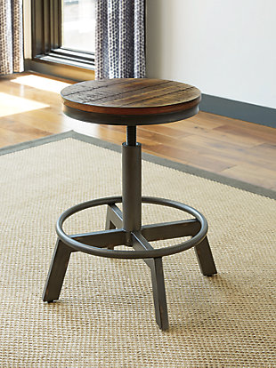 Stretch the possibilities of small space living with the Torjin 3-piece long counter table set with two retro-cool stools. Two-tone finish scheme of distressed warm brown and aged gunmetal is full of urban industrial swagger. Long length makes it suitable for 3 people to sit. Place behind your sofa for a chic eating or working space.Includes counter height table and 2 stools | Table made of veneers, wood and engineered wood | Stools made of veneers and engineered wood with metal base and adjustable height | Seats 3 | Assembly required | Estimated Assembly Time: 75 Minutes
