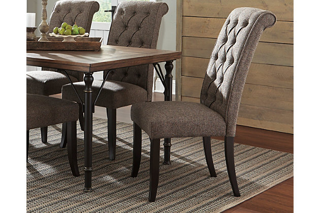 Tripton arrives at the table with the full scale comfort of a favorite living room chair. Classic tufting dresses up the high, beautifully curved back. Both seat and back are firmly cushioned and covered in a textured upholstery.Wood frame | Firm, yet comfortable cushioned seat and back | Seat and back covered in polyester upholstery | Slightly curved legs in an aged finish | Assembly required | Excluded from promotional discounts and coupons | Estimated Assembly Time: 30 Minutes
