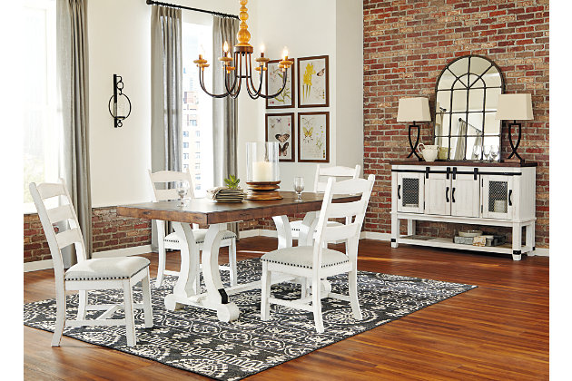 A high-style choice for casual spaces, the Valebeck dining table serves up the best in rustic farmhouse living. Two-tone distressed finish pairs a brown tabletop with a vintage white base for a double helping of charm. Extension dining table features an extra thick edge with book matched inlay veneer for such a distinctive twist.Made of pine wood, veneer and engineered wood | Two-tone finish | Black metal accents | Table extends by pulling both ends and dropping in leaf | Seats up to 8 fully extended | Assembly required | Estimated Assembly Time: 45 Minutes