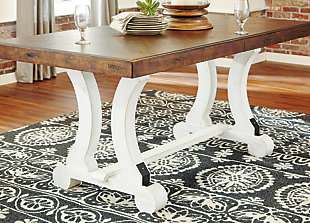 A high-style choice for casual spaces, the Valebeck dining table serves up the best in rustic farmhouse living. Two-tone distressed finish pairs a brown tabletop with a vintage white base for a double helping of charm. Extension dining table features an extra thick edge with book matched inlay veneer for such a distinctive twist.Made of pine wood, veneer and engineered wood | Two-tone finish | Black metal accents | Table extends by pulling both ends and dropping in leaf | Seats up to 8 fully extended | Assembly required | Estimated Assembly Time: 45 Minutes