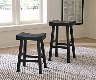 Saddle up and prepare to feast in total comfort and style. The Glosco counter height saddle stool's deeply scooped seat offers ample support through multiple courses (or rounds of drink). Contrasting finishes elevate the classic shape, creating a look that keeps you coming back for seconds.Made of wood | Antiqued black finish | Saw kerf distressing | Comfortable footrest | Counter height | Assembly required | Estimated Assembly Time: 30 Minutes